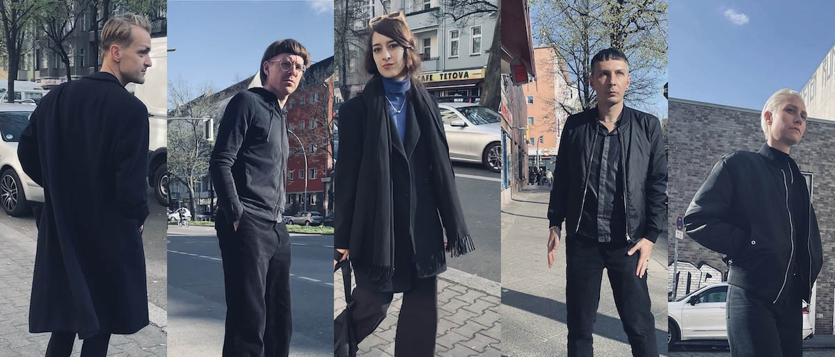 The band photo of Ja, Panik consists of five individual pictures of the band members edited together. All five are wearing black clothes and are in front of different urban backgrounds - cars, houses, streets can be seen. From left to right: Sebastian Janata, Stefan Pabst, Rabea Erradi, Andreas Spechtl, Laura Landergott.